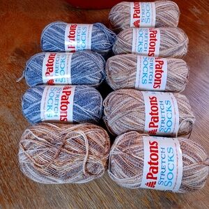 NWT 9 skeins of light weight stretchy sock yarn. 3 grey/white, 6 brown/cream